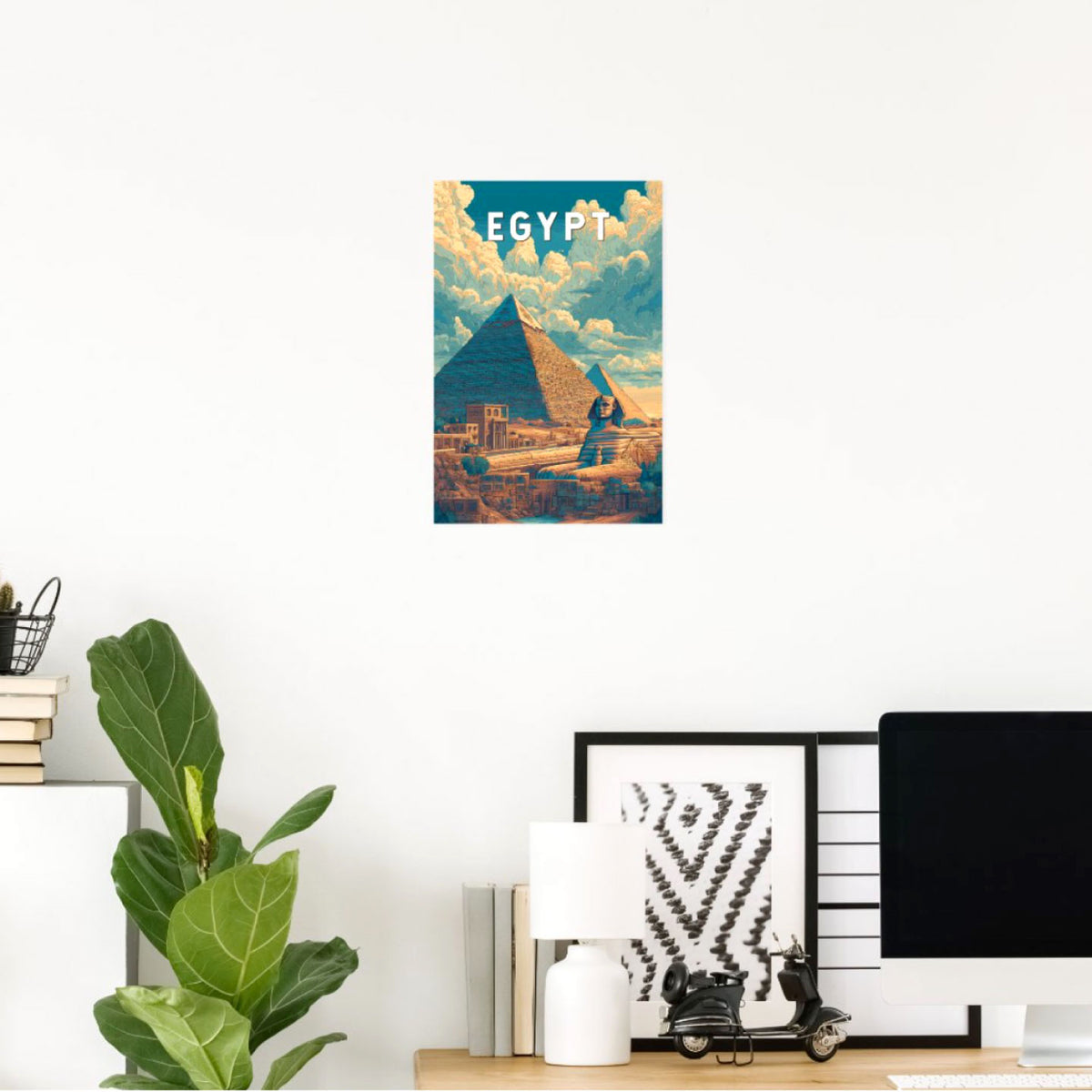 VERTICAL EGYPT TRAVEL POSTER FEATURING THE GREAT PYRAMID OF GIZA AND SPHINX WITH A SUNBEAM, DISPLAYED ABOVE A MODERN DESK ON A WHITE WALL.