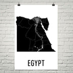 MINIMALIST EGYPT MAP POSTER FEATURING A BLACK SILHOUETTE MAP WITH ROADS AND THE NILE RIVER, DISPLAYED ON A WHITE BRICK WALL.