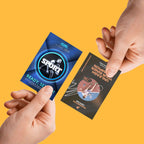 TWO HANDS HOLDING CUSTOM PRINTED SPORTS TRADING CARDS WITH FULL-COLOR GRAPHICS AGAINST A SOLID YELLOW BACKGROUND