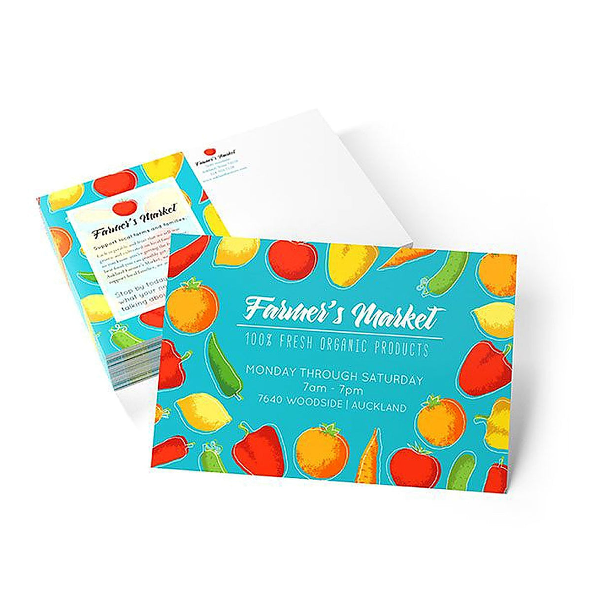 CUSTOM PRINTED FARMERS MARKET POSTCARD WITH COLORFUL VEGETABLE ILLUSTRATIONS AND WHITE ENVELOPE ON A CLEAN BACKGROUND.