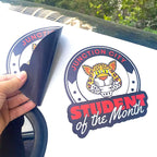 CUSTOM PRINTED CONTOUR-CUT MAGNETIC SIGN FEATURING JUNCTION CITY STUDENT OF THE MONTH GRAPHICS WITH A LEOPARD MASCOT, SHOWN APPLIED TO A WHITE VEHICLE WITH THE FLEXIBLE MAGNETIC MATERIAL PARTIALLY LIFTED.