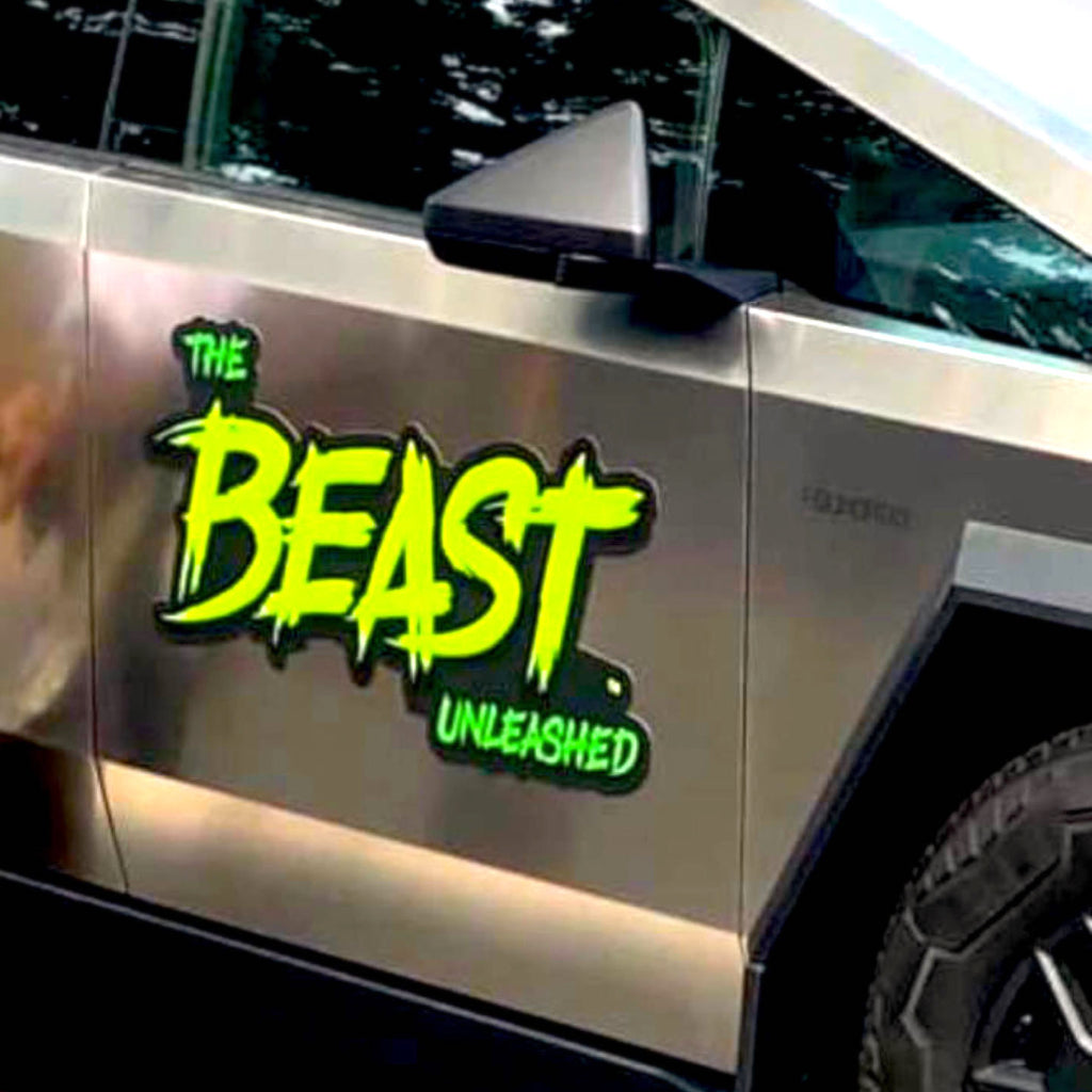 CUSTOM PRINTED CONTOUR-CUT MAGNETIC VEHICLE SIGN FEATURING “THE BEAST UNLEASHED” GREEN AND BLACK GRAPHICS, APPLIED TO THE DOOR OF A METALLIC SILVER TESLA CYBERTRUCK.