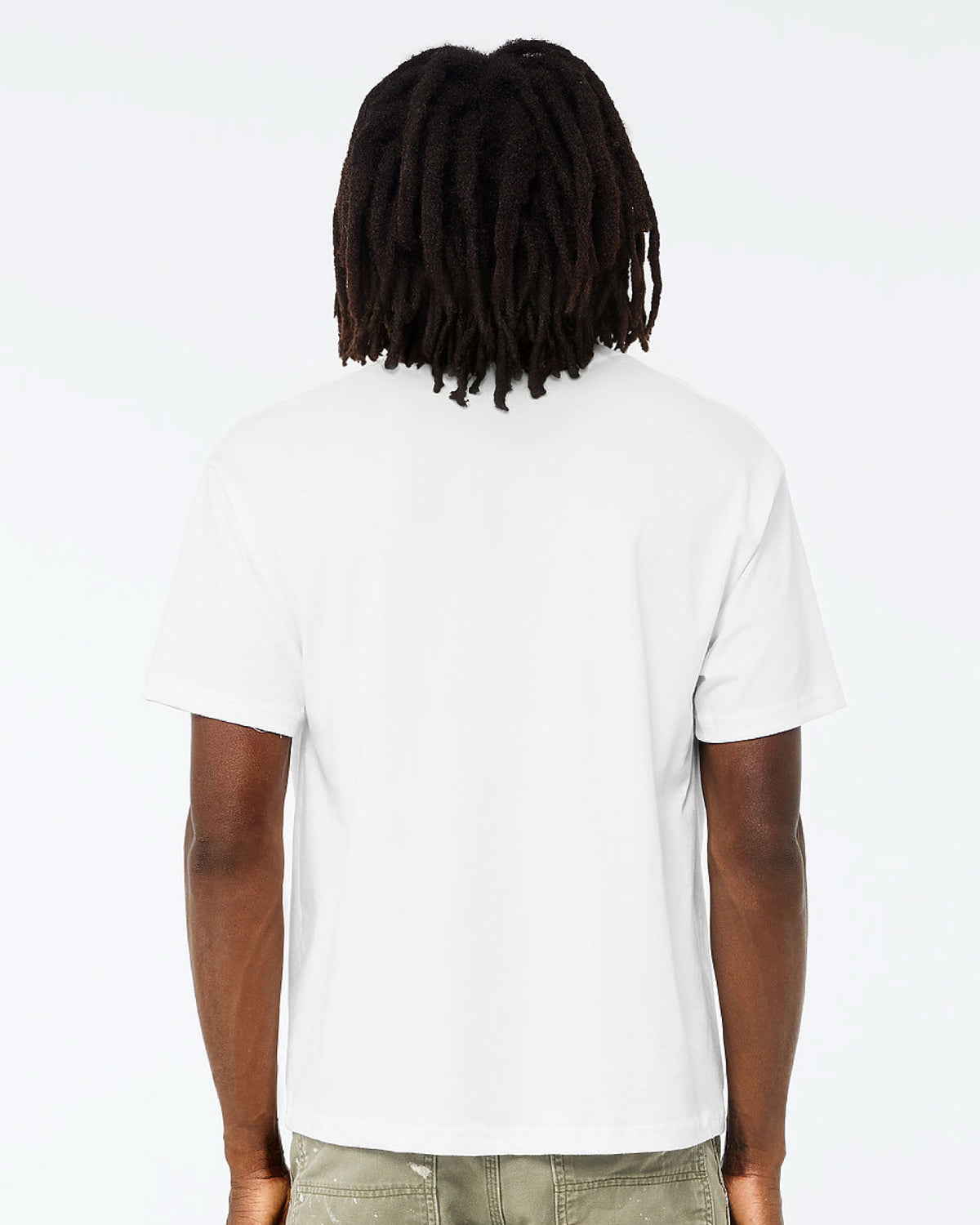 A man viewed from behind wearing a plain white short-sleeve t-shirt and olive green pants, set against a solid white studio background.