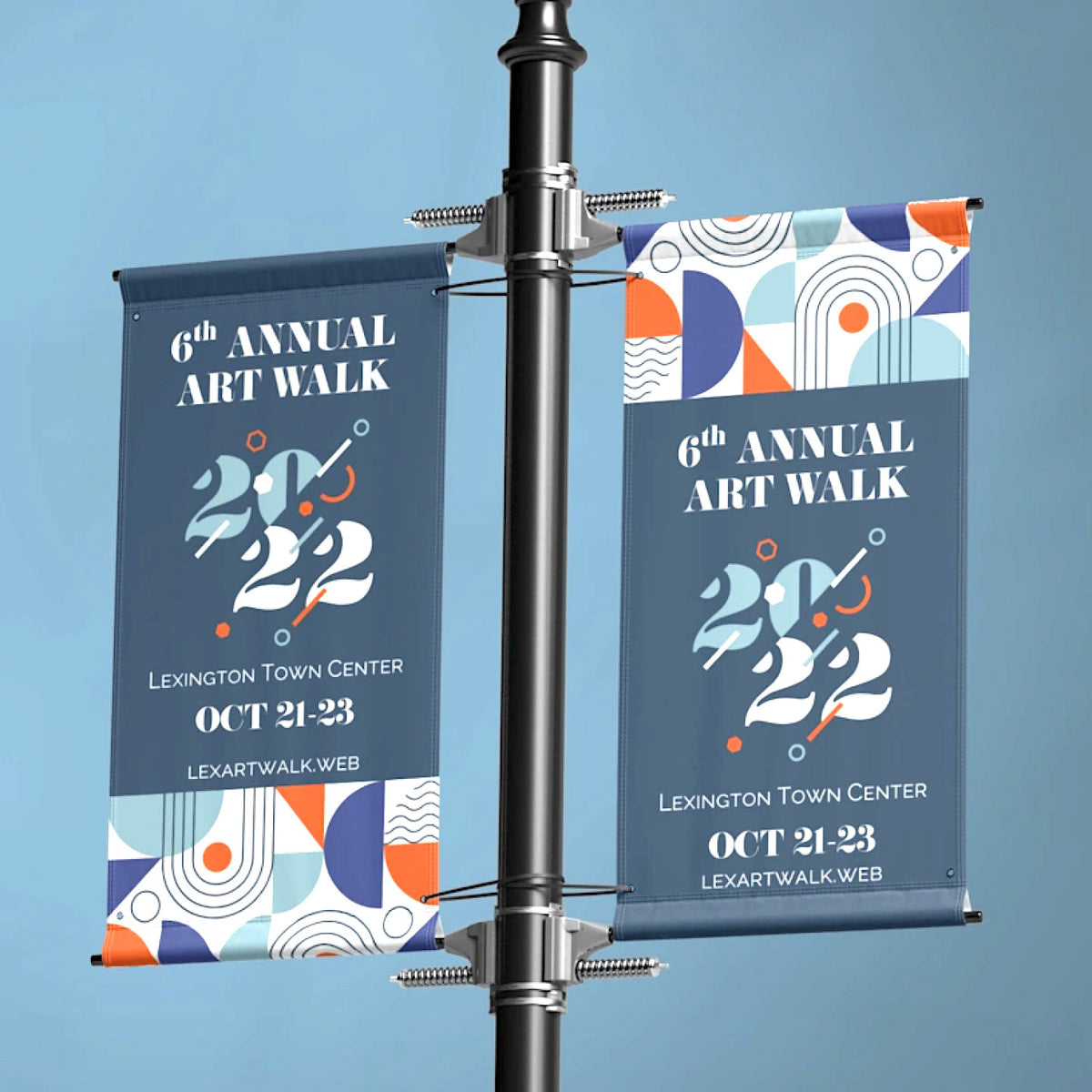 WO CUSTOM PRINTED VINYL SCRIM EVENT BANNERS FEATURING 6TH ANNUAL ART WALK GRAPHICS, MOUNTED VERTICALLY ON AN OUTDOOR STREET POLE AGAINST A BLUE SKY.