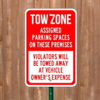 CUSTOM PRINTED ALUMINUM TOW ZONE PARKING SIGN FEATURING BOLD RED AND WHITE WARNING GRAPHICS WITH ASSIGNED PARKING AND VEHICLE TOWING INFORMATION, DISPLAYED OUTDOORS ON A METAL GREEN POST.