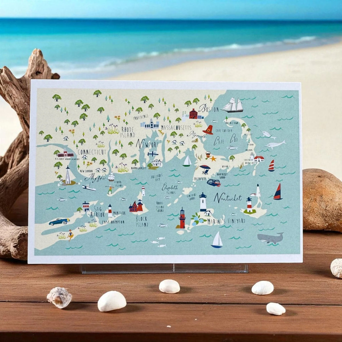 CUSTOM PRINTED ILLUSTRATED MAP CARD FEATURING A NAUTICAL ISLAND DESIGN WITH LIGHTHOUSES, SAILBOATS, PALM TREES, AND LANDMARKS DISPLAYED ON A WOODEN SURFACE.