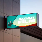 CUSTOM PRINTED TRANSLUCENT BACKLIT SIGN INSERT FEATURING VIBRANT BACKLIT FILM GRAPHICS WITH A TEAL-TO-YELLOW GRADIENT, ILLUMINATED IN AN LED LIGHT BOX MOUNTED ON A BUILDING EXTERIOR.