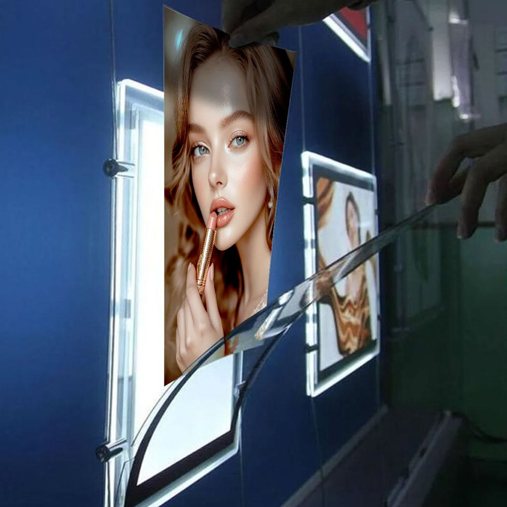 CUSTOM PRINTED TRANSLUCENT BACKLIT SIGN INSERT FEATURING A BEAUTY PORTRAIT OF A WOMAN APPLYING LIPSTICK, ILLUMINATED IN A VERTICAL LED LIGHT TRANSLUCENT ACRYLIC SURFACES MOUNTED ON A DARK BLUE WALL.
