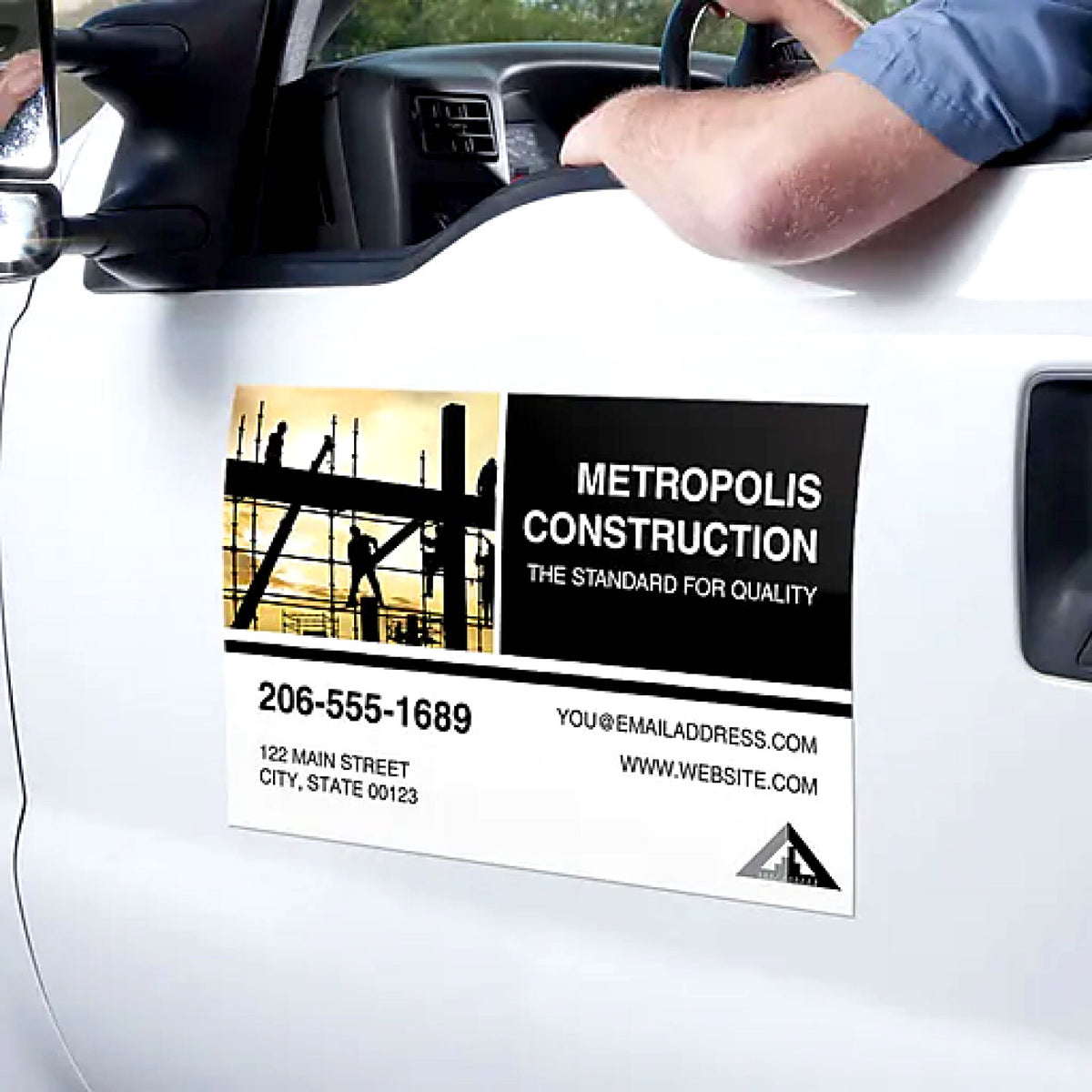 CUSTOM PRINTED VEHICLE MAGNET SIGN FEATURING METROPOLIS CONSTRUCTION BUSINESS BRANDING AND CONTACT INFORMATION, APPLIED TO THE DOOR OF A WHITE TRUCK FOR REMOVABLE BUSINESS ADVERTISING.